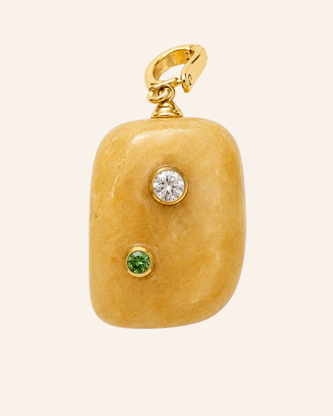 Calcite pendant with a moissanite and peridot on a cream background