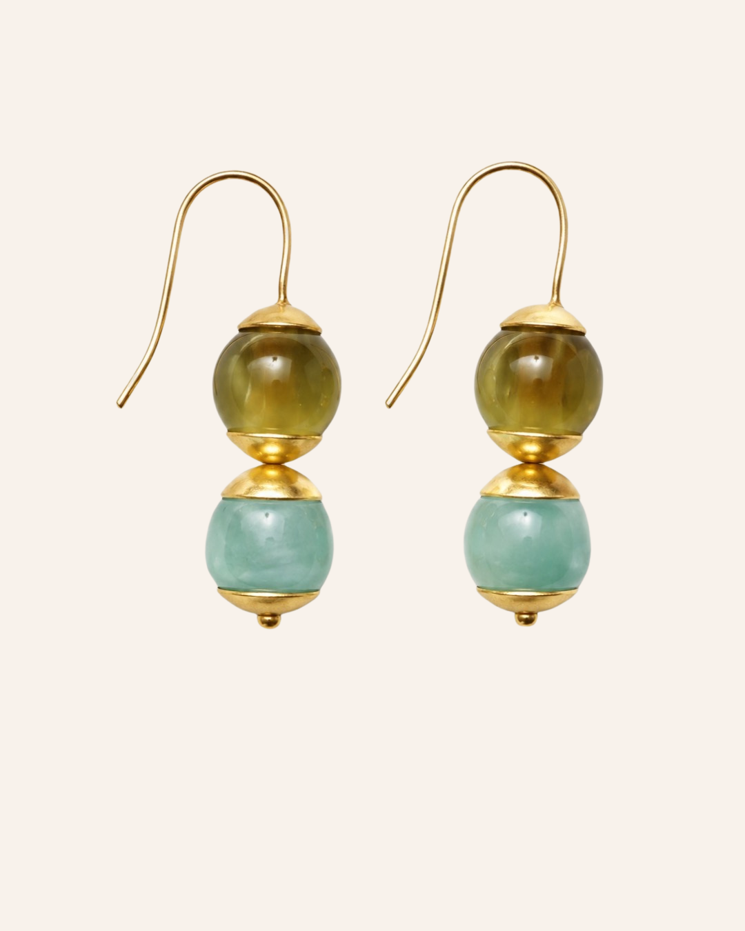 A pair of gold-tone dangle earrings with two stacked round beads, one olive green and one light aqua blue, shown on a plain light beige background.
