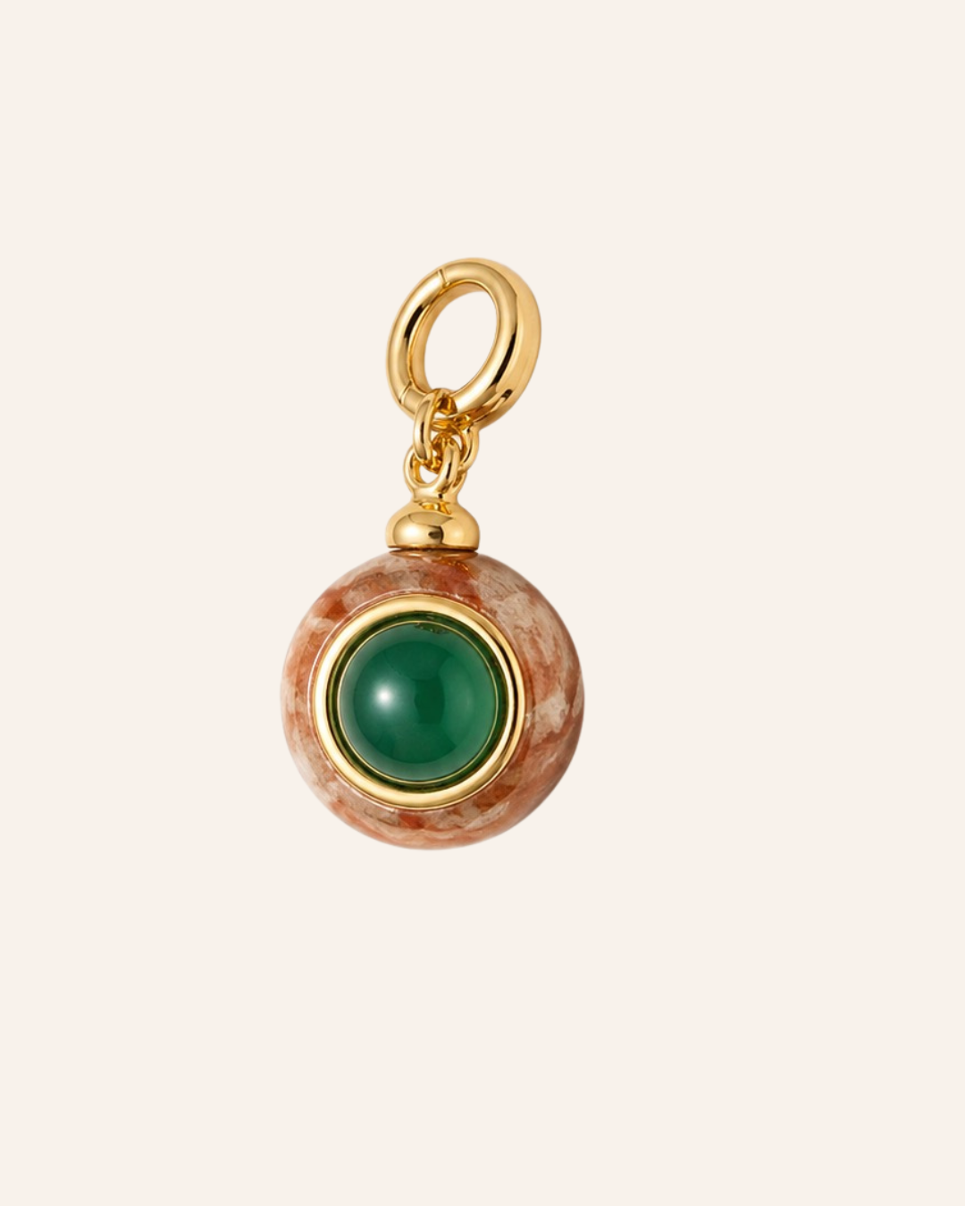 A round pendant charm featuring a polished green stone in the center, surrounded by a gold bezel and a textured brown and white marbled outer ring, with a gold hanging loop at the top, shown on a solid pale beige background.