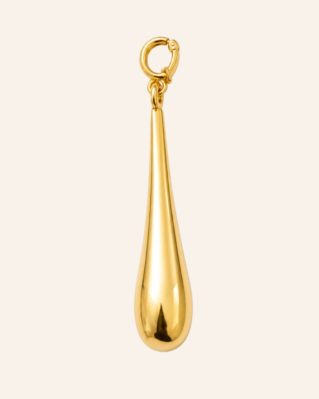 A polished gold teardrop-shaped pendant charm with a small top loop, shown against a solid off-white background.