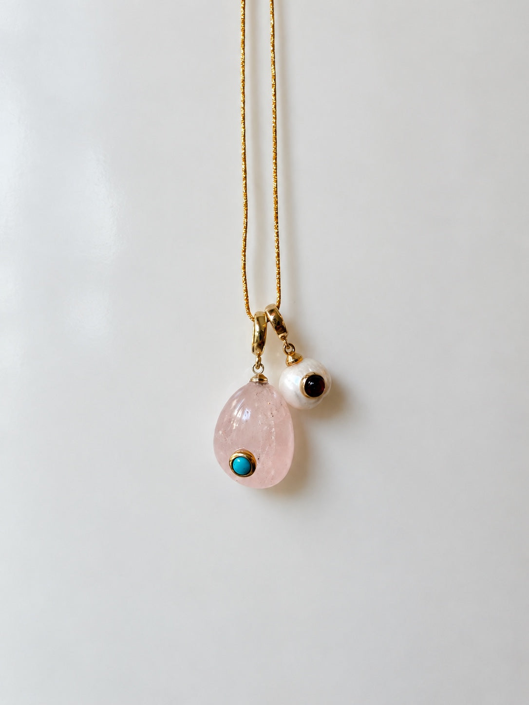 Alba rose quartz Relic paired with a pearl Relic on a gold chain