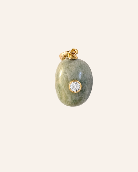 Drift Relic No. 02, natural pale green-gray stone with bezel-set moissanite and gold clasp on warm ivory