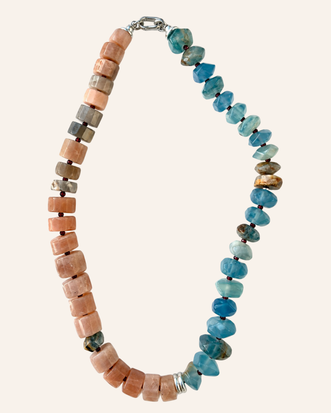 Maia Statement Collar with peach moonstone on one side, blue calcite on the other, garnet spacers and silver details