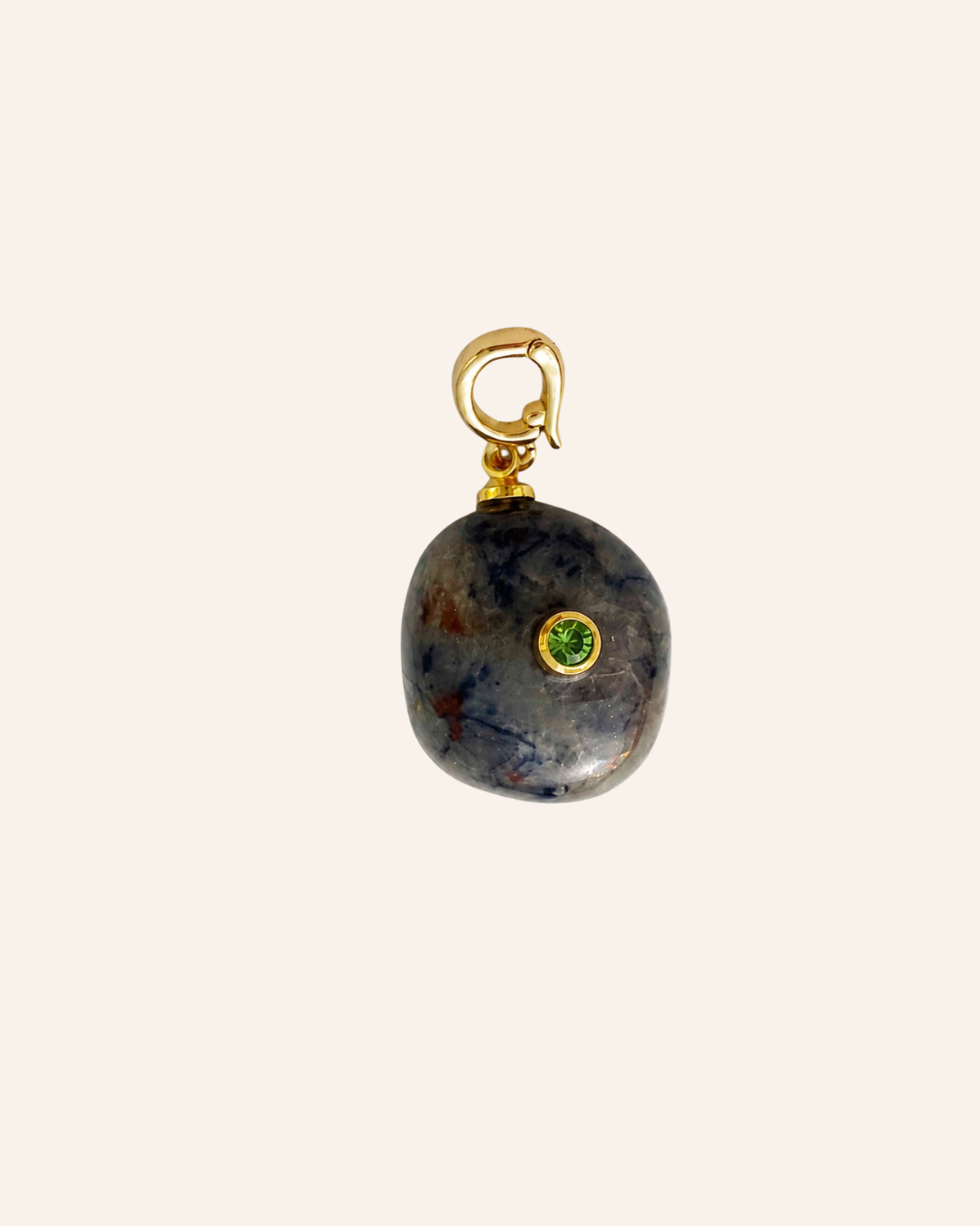 Vesper Relic, tumbled sodalite in blue-gray tones with natural rust-colored markings, bezel-set green peridot and gold-tone clasp